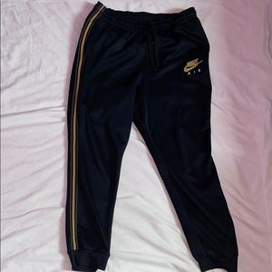 black and gold Nike pants